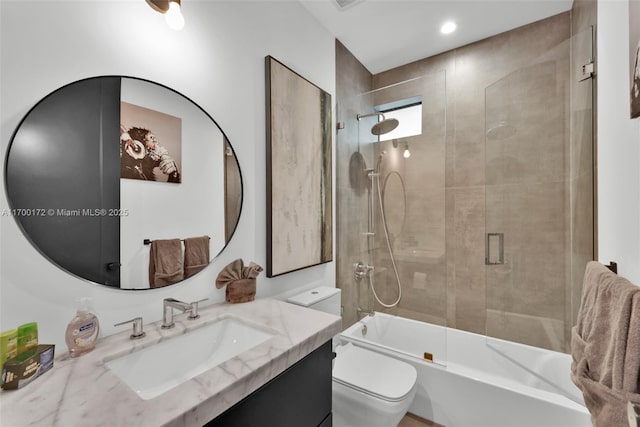 full bathroom featuring vanity, toilet, and combined bath / shower with glass door