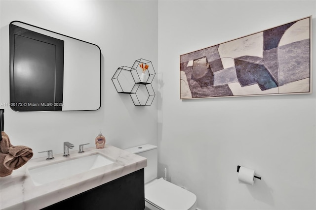 bathroom with vanity and toilet