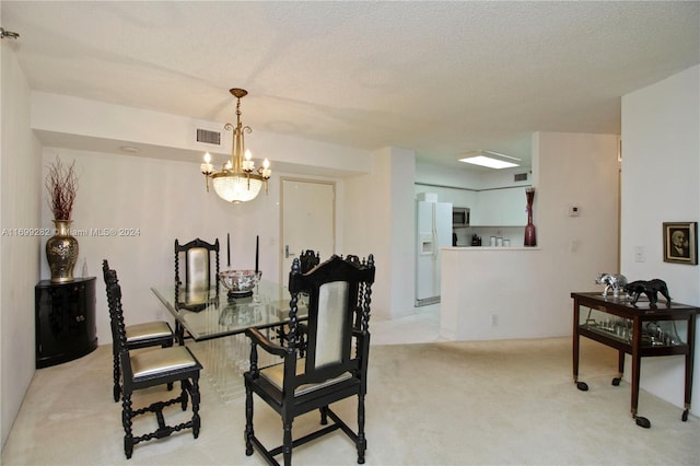 dining space with light colored carpet, a textured ceiling, and a notable chandelier