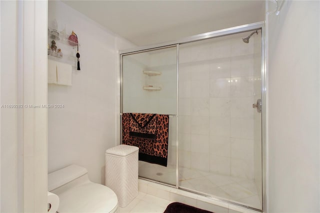 bathroom featuring toilet and walk in shower