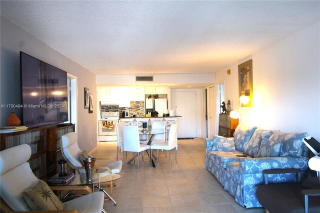 living room with light tile patterned floors and a textured ceiling