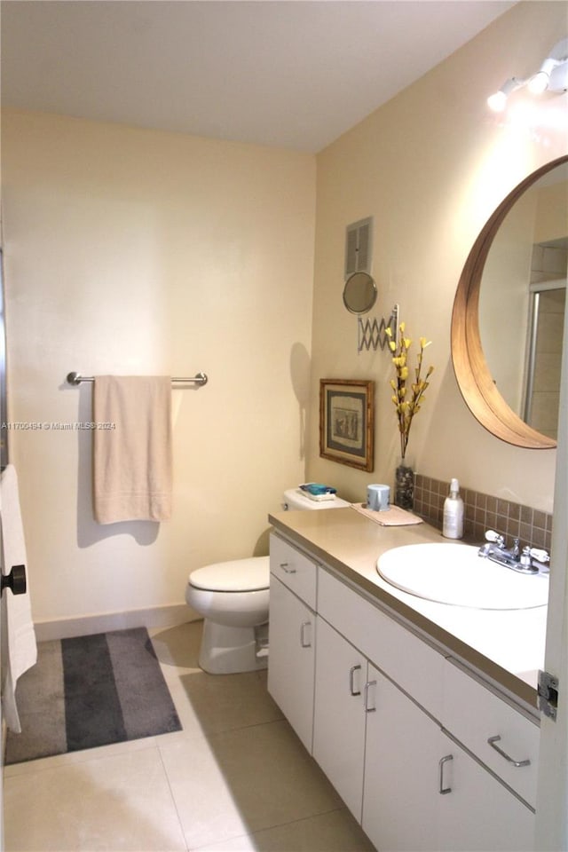 bathroom featuring toilet, vanity, and tile patterned floors