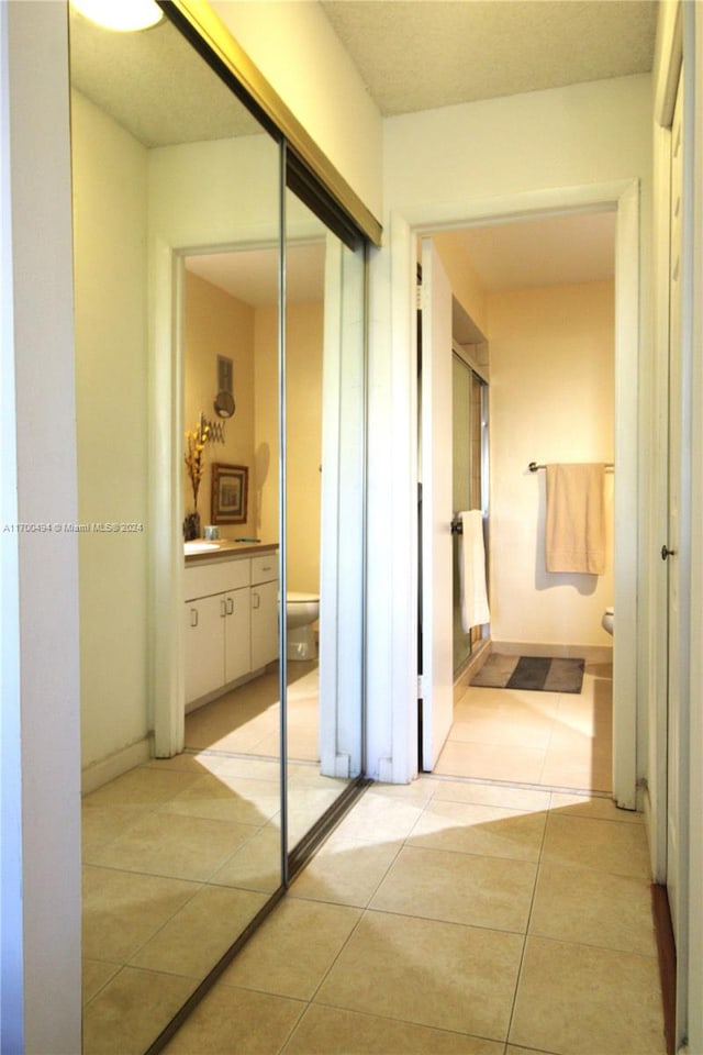 hall with light tile patterned floors