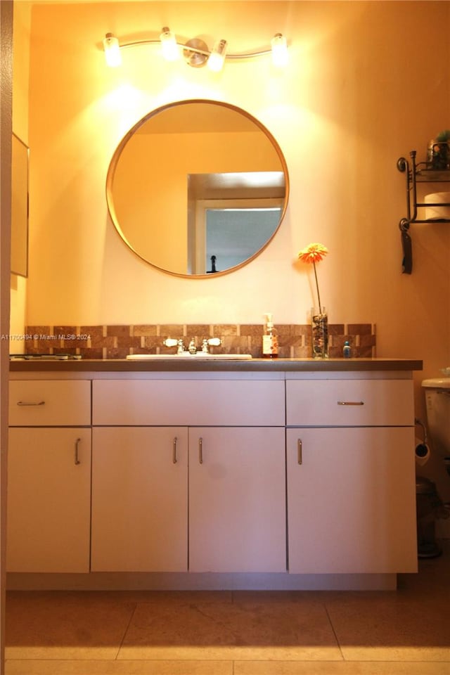 bathroom featuring tile patterned floors, vanity, and toilet