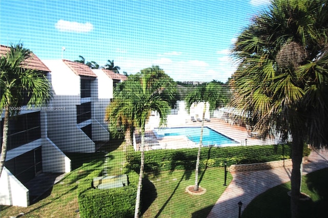view of pool with a yard