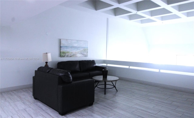 living room featuring coffered ceiling and light wood-type flooring