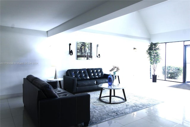 tiled living room featuring vaulted ceiling