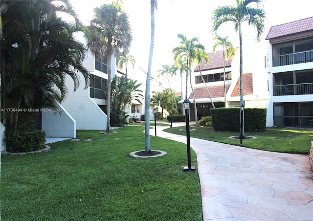 view of property's community with a lawn