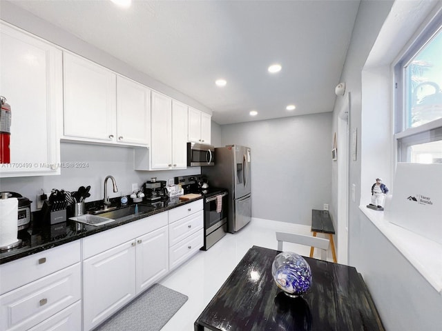 kitchen with sink, white cabinetry, and stainless steel appliances