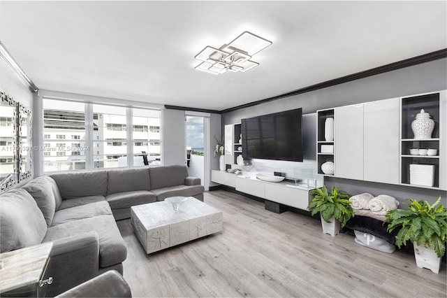 living room with light wood-type flooring and crown molding