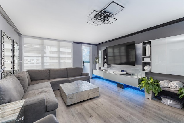 living room with light hardwood / wood-style floors and ornamental molding