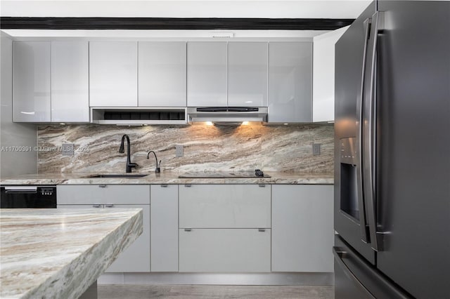 kitchen with decorative backsplash, white cabinetry, and black appliances