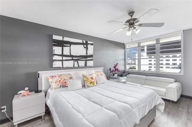 bedroom with ceiling fan and wood-type flooring