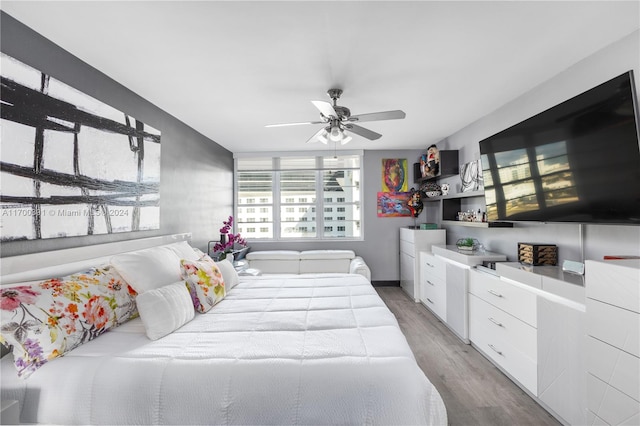 bedroom with hardwood / wood-style floors and ceiling fan