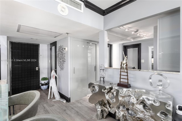 bathroom with a bathtub and hardwood / wood-style flooring