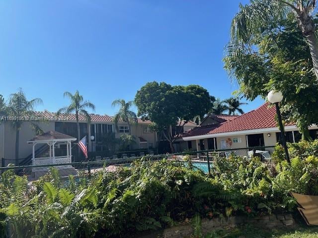 back of property featuring a gazebo