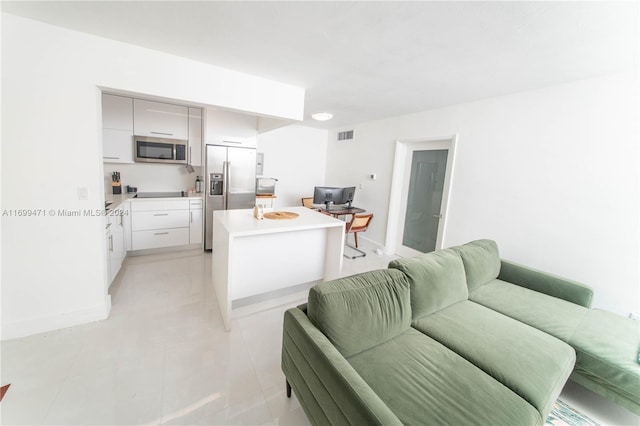 kitchen with light tile patterned flooring and appliances with stainless steel finishes