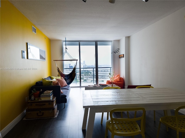 dining room featuring a textured ceiling, dark hardwood / wood-style flooring, and a wealth of natural light