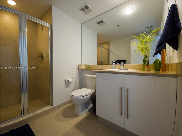 bathroom with vanity, tile patterned floors, and a shower with shower door