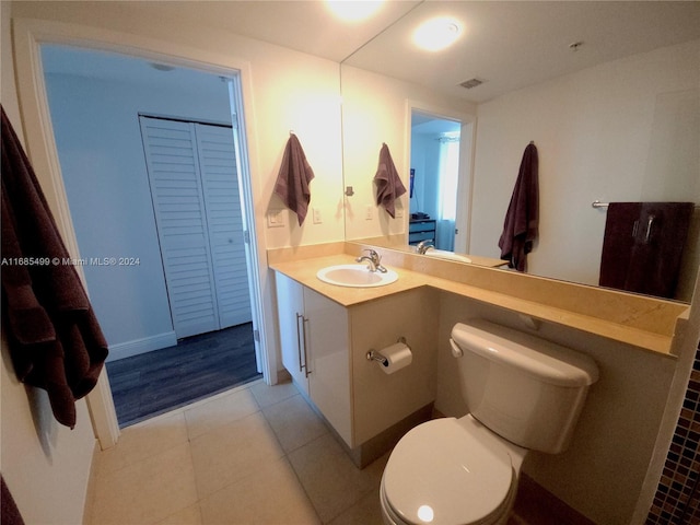 bathroom with vanity, hardwood / wood-style flooring, and toilet