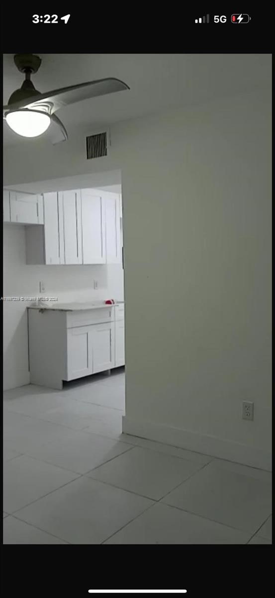 kitchen with white cabinetry and light tile patterned floors