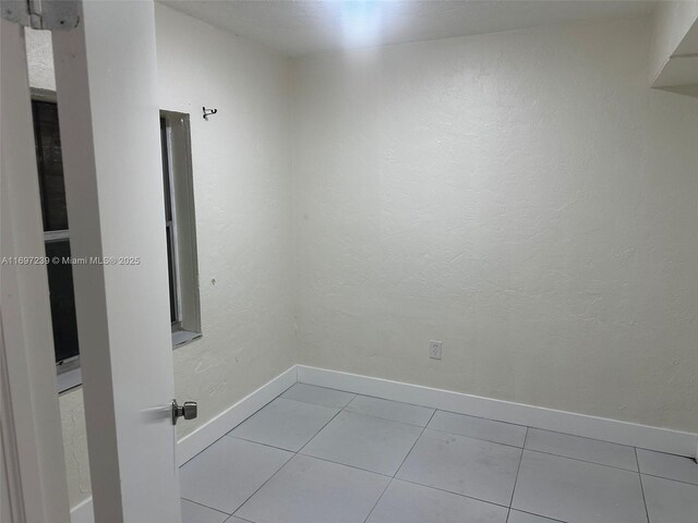 tiled spare room with baseboards
