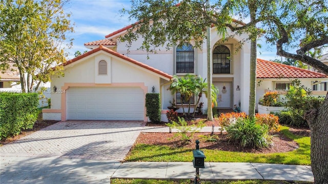 mediterranean / spanish-style home featuring a garage