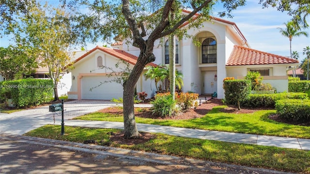 mediterranean / spanish-style house with a garage