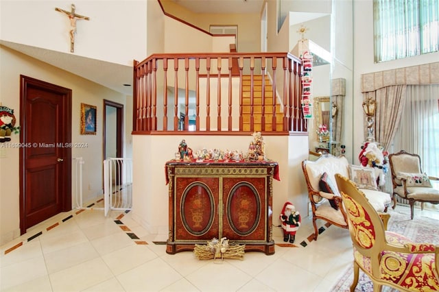 foyer with tile patterned flooring and a high ceiling