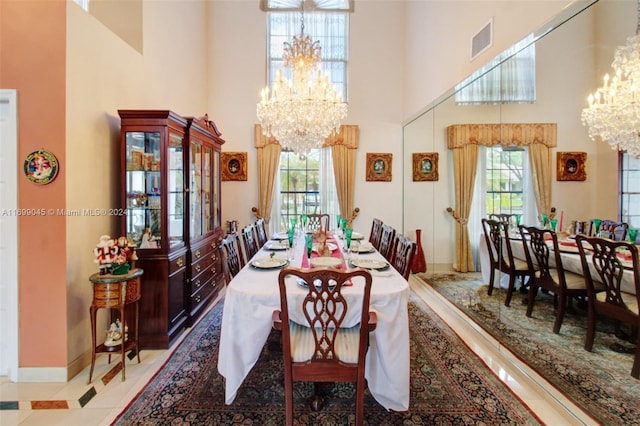 dining room with a chandelier and a towering ceiling