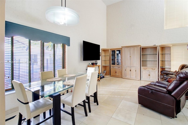 tiled dining area featuring a high ceiling