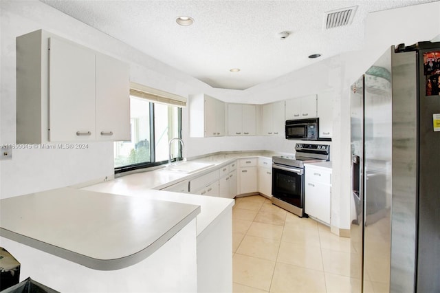 kitchen with sink, a textured ceiling, white cabinetry, kitchen peninsula, and stainless steel appliances