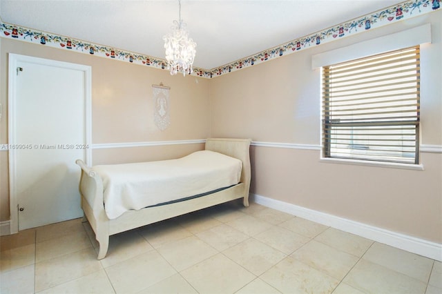 tiled bedroom with a chandelier