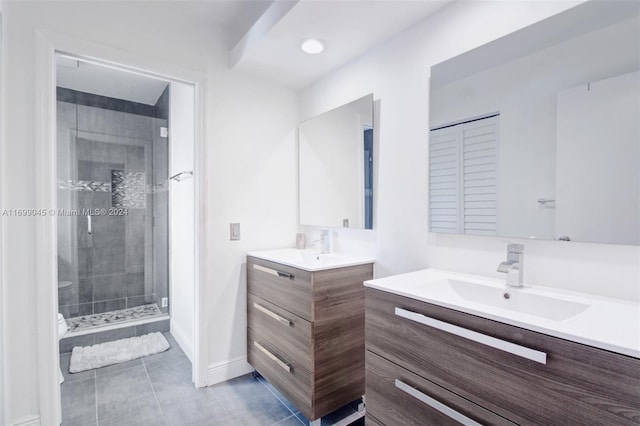 bathroom featuring tile patterned flooring, vanity, toilet, and a shower with door