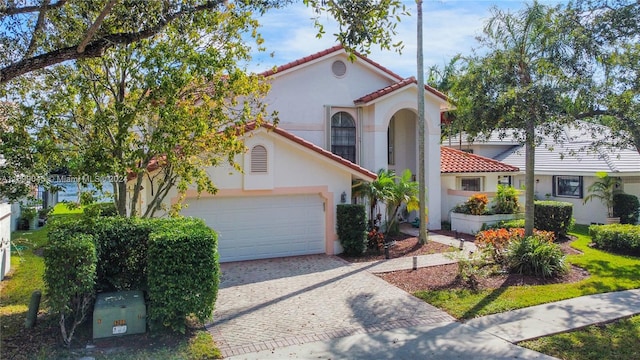 mediterranean / spanish-style house with a garage