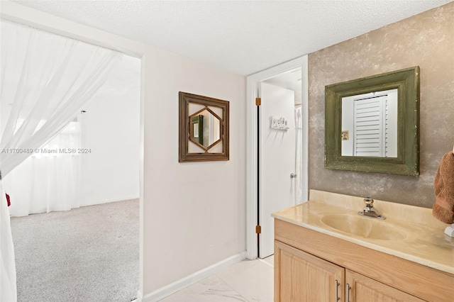 bathroom with vanity and a textured ceiling