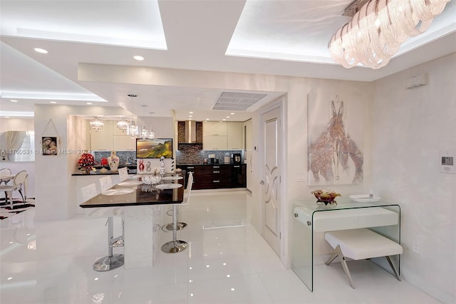 interior space with light tile patterned floors and a tray ceiling