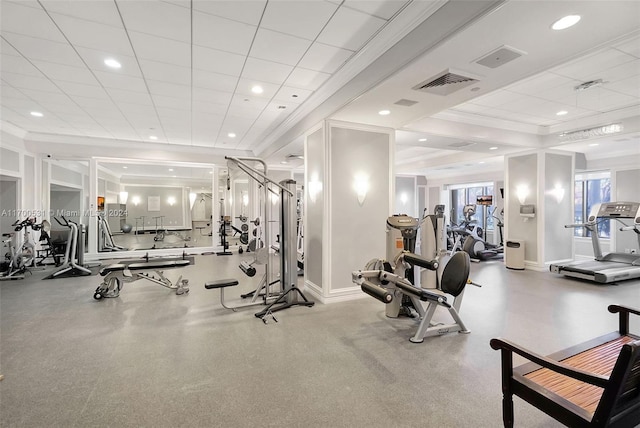 gym with a drop ceiling and ornamental molding