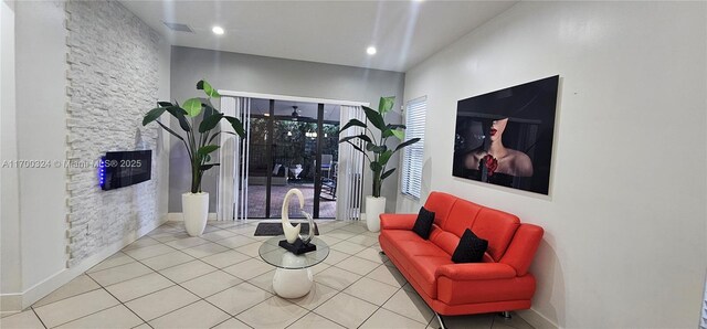 living room with light tile patterned flooring and an inviting chandelier