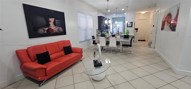 tiled dining space with a chandelier