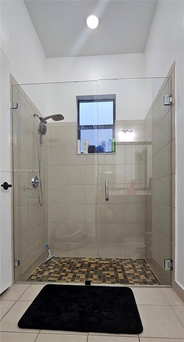 bathroom with tile patterned floors and an enclosed shower