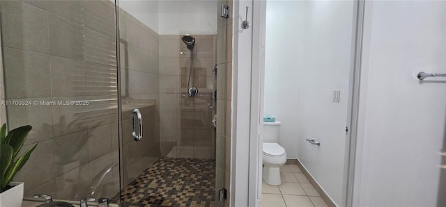 bathroom featuring an enclosed shower, tile patterned flooring, and toilet