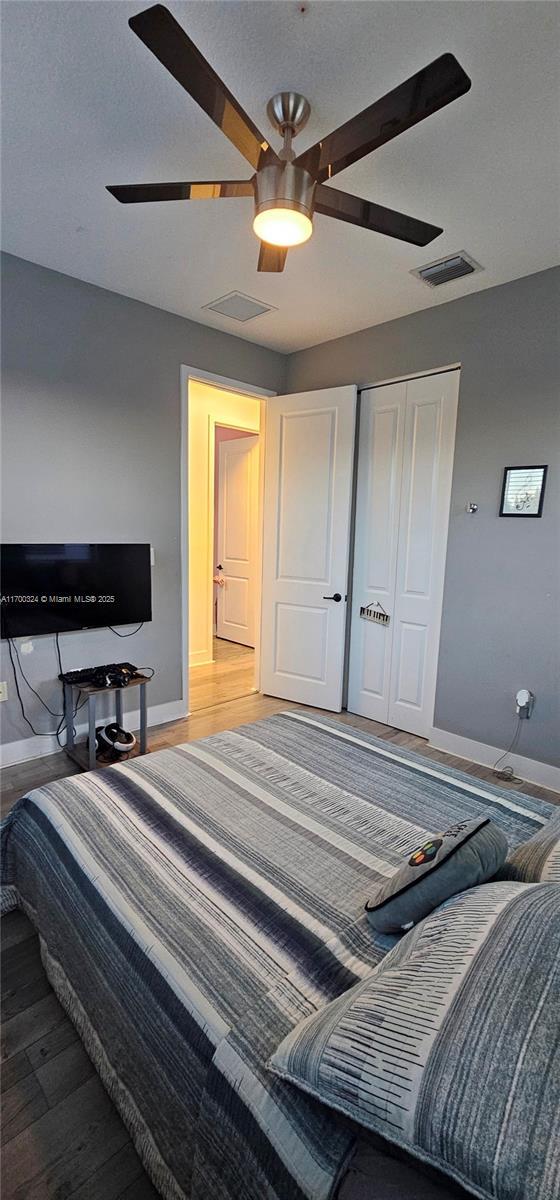 bedroom with ceiling fan and wood-type flooring