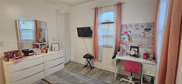 bedroom with hardwood / wood-style flooring