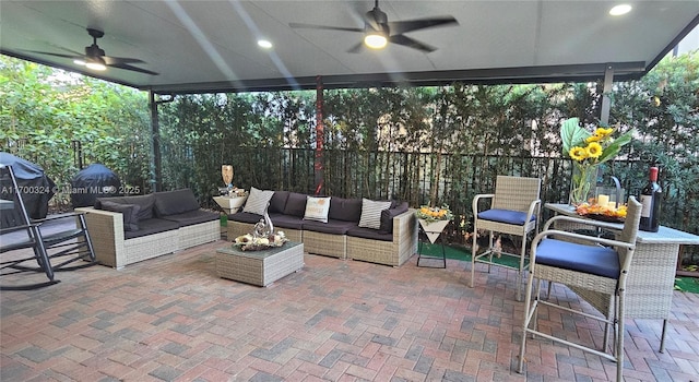 view of patio / terrace featuring ceiling fan, an outdoor living space, and grilling area