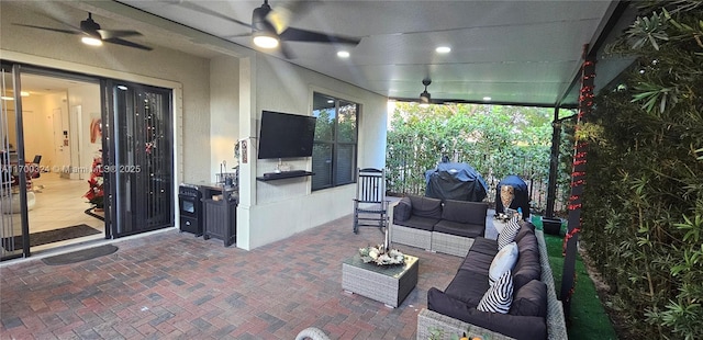 view of patio with an outdoor living space and ceiling fan