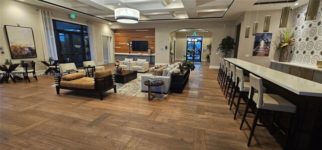 dining area featuring a tray ceiling and coffered ceiling