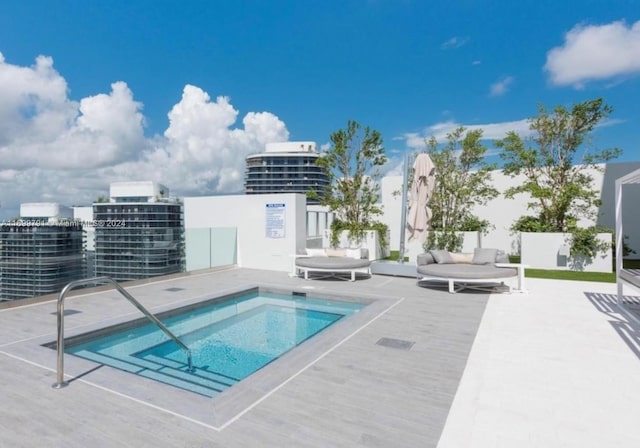 view of swimming pool featuring a community hot tub