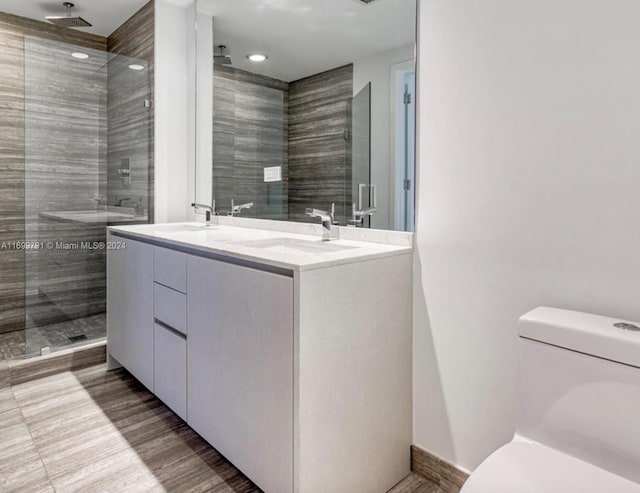 bathroom with vanity, toilet, and an enclosed shower