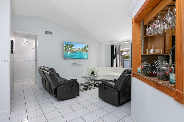 tiled living room featuring a textured ceiling and lofted ceiling